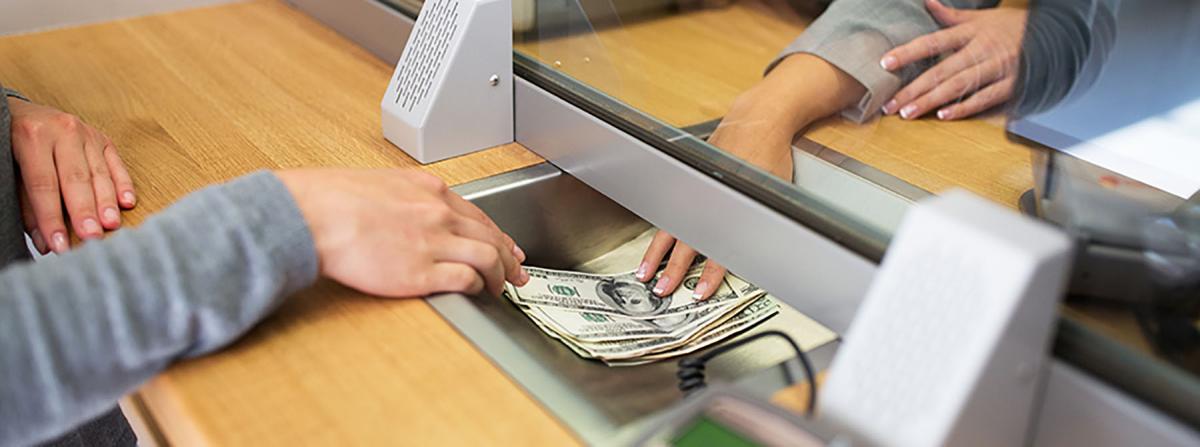 People exchanging money at a bank.