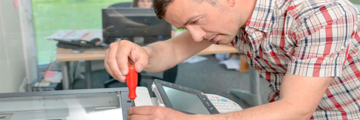 Repairman working on Multifunction Printers in Quincy MA